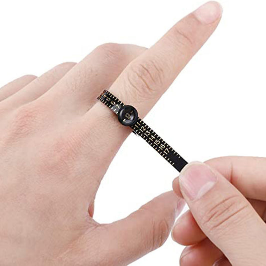 Measure the size of your finger with a magnifying glass ring and a ring tape measure