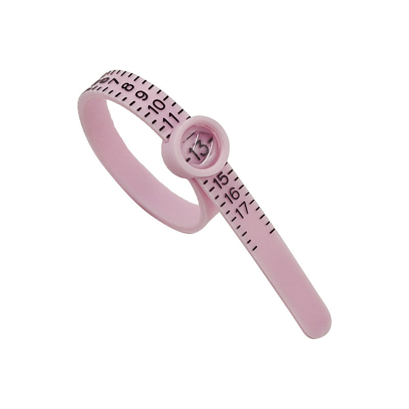 Measure the size of your finger with a magnifying glass ring and a ring tape measure